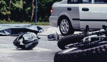 Motorcycle Helmet On The Street After Terrible Car Crash